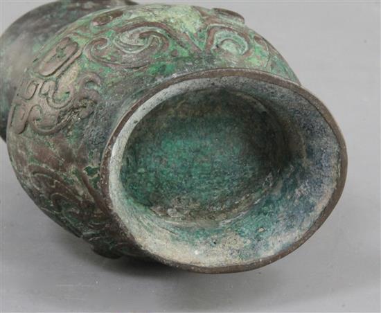 A small Chinese archaic bronze ritual wine cup, Zhi, Western Zhou dynasty, 11th century B.C., 11cm high, hole and rim repairs